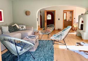a living room with a couch and chairs at KitzMoments by Belle Stay in Reith bei Kitzbühel