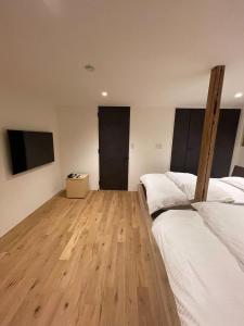 a bedroom with two beds and a flat screen tv at the terrace sumoto - Vacation STAY 24588v in Sumoto