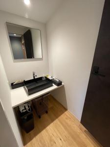 a bathroom with a sink and a mirror at the terrace sumoto - Vacation STAY 24588v in Sumoto