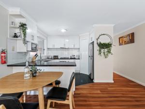 a kitchen and dining room with a wooden table at PRIVATE ROOM 1 and PRIVATE ROOM 3 beside Monash University in Clayton in Clayton North