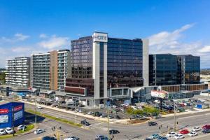 a large building with cars in a parking lot at PRIVATE ROOM 1 and PRIVATE ROOM 3 beside Monash University in Clayton in Clayton North