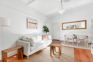 a living room with a couch and a table at Acland Art Deco - Coastal Chic by St Kilda Beach in Melbourne