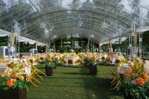 a large marquee with tables and chairs and flowers at Philea Resort & Spa in Melaka