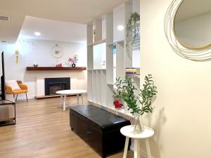 a living room with a fireplace and a mirror at 3Beds 2BA Cherry Blossom Suite - Free Parking - Central Oakridge Neighbourhood in Vancouver