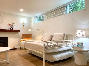 a bedroom with a bed and a fireplace at 3Beds 2BA Cherry Blossom Suite - Free Parking - Central Oakridge Neighbourhood in Vancouver
