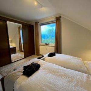 a bedroom with a bed and a large window at HarzBlick 642 in Braunlage