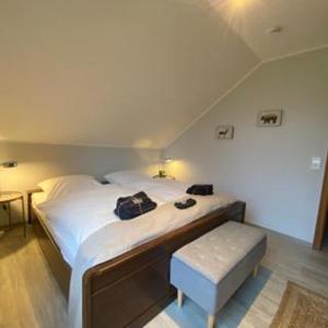 a bedroom with a large bed and a stool at HarzBlick 642 in Braunlage
