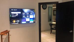 a flat screen tv on a wall in a room at Ocean View 2 BR Condo in Tijuana +8 photos