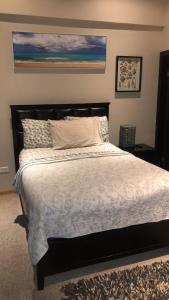 a bedroom with a large bed with white sheets at Ocean View 2 BR Condo in Tijuana