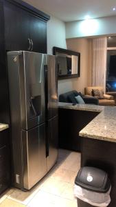 a kitchen with a large stainless steel refrigerator at Ocean View 2 BR Condo in Tijuana