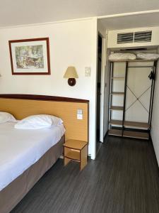 a bedroom with a bed and a bunk bed at Hôtel Campanile Cahors in Cahors