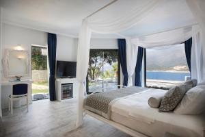 a bedroom with a bed with a view of the ocean at Alley Prime Hotel in Kaş