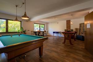a billiard room with a pool table and tables at Zur Schmitte in Schmallenberg