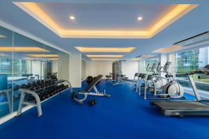 a gym with treadmills and elliptical machines at Phuket Airport Condotel in Thalang