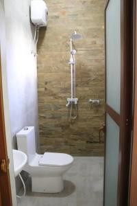 a bathroom with a toilet and a shower at Verified Lodge in Dodoma