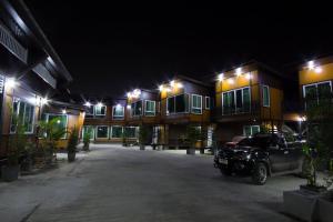 a car parked in front of a building at night at TG Home Residence in Chiang Rai