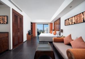 a hotel room with a bed and a couch at Mangrove Tree Resort World Sanya Bay-Kapok in Sanya