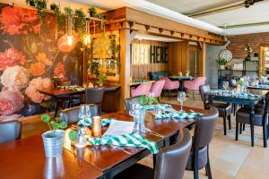 a restaurant with wooden tables and pink chairs at Zur Schmitte in Schmallenberg