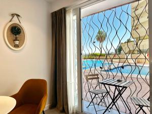 a room with a balcony with a view of a pool at Loft 18 Beachfront Marbella Center in Marbella
