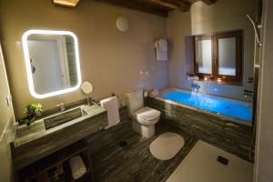 a bathroom with a tub and a toilet and a sink at Casa Juancito in Santiago de Compostela +9 photos