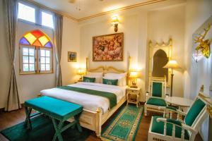 a bedroom with a bed and a table and chairs at The Royal Hermitage - Best Luxury Boutique Hotel Jaipur in Jaipur
