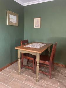 a dining room table with chairs at Bee Cozy in Waterfall