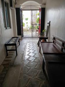 an empty room with benches and a door with a gate at Villa Tomasa Boracay Dmall in Boracay