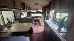 a kitchen and dining room in an rv at Maylands - -Where memories are made. in Stanford le Hope