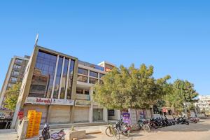 a building with motorcycles parked in front of it at Hotel Relax Inn in Gandhinagar