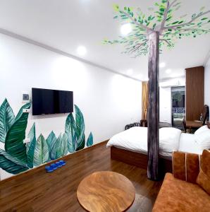 a bedroom with a palm tree mural on the wall at Amelié Homestay in Hanoi
