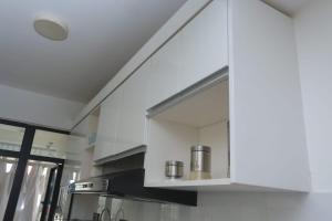 a kitchen with white cabinets and a stove at Urban Oasis Apartment by Edmor Suites in Nairobi