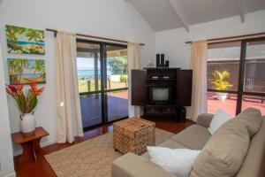 a living room with a couch and a tv at Vai Villas in Avarua