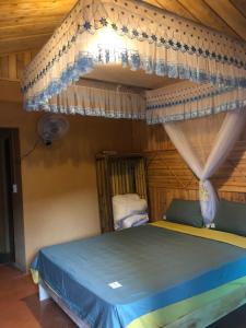 a bedroom with a bed with a canopy at Lý Tà Quân Homestay in Ha Giang