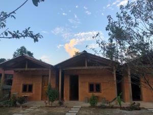 a house with a blue sky in the background at Lý Tà Quân Homestay in Ha Giang