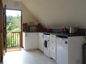 a kitchen with a washer and dryer in a room at HAYNE BARN ESTATE - Froggies - Independent Self contained studio on private estate in Postling