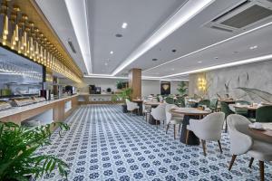 a dining room with tables and chairs in a restaurant at Rayelin Hotel Istanbul Old City Special Category in Istanbul