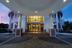 a large building with columns and a large glass door at Alba Queen Hotel in Side