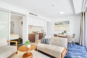 a living room with a couch and a table at 219 Harbour Lights with Ocean Views in Cairns