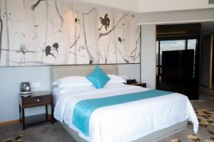 a bedroom with a large bed and a television at Huaqiang Plaza Hotel Shenzhen, Enjoy Complimentary Mini Bar & Night Snack, Add breakfast - enjoy complimentary afternoon tea in Shenzhen