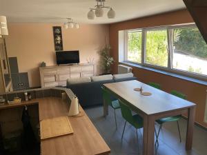 a living room with a table and a couch at Le Petit Parc in Wavre