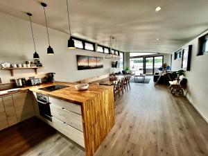 a kitchen with wooden counter tops and a living room at Houseboat Islay in Bembridge