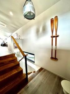 a room with stairs and skis on the wall at Houseboat Islay in Bembridge