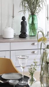 a dining room table with a candle and a vase at Villa Marikollen in Hektner