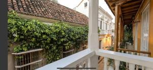 a building with a green hedge on the side of it at Luxury Large Apartment With Colonial Balcony in Cartagena de Indias