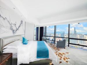 a bedroom with a bed and a large window at Huaqiang Plaza Hotel Shenzhen, Enjoy Complimentary Mini Bar & Night Snack, Add breakfast - enjoy complimentary afternoon tea in Shenzhen