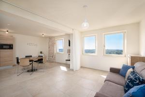 a living room with a couch and a table at La casa di Cristina - apartments with sea view! in Vrsar