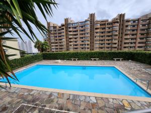 a swimming pool in front of a large building at SARDINERO in Santander