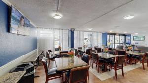 a dining room with tables and chairs and blue walls at Days Inn by Wyndham Orlando Downtown in Orlando