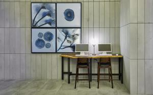 a table with two monitors on it in a room at Hotel Riverside Ulsan in Ulsan