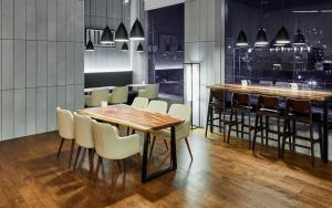 a restaurant with a table and chairs and a bar at Hotel Riverside Ulsan in Ulsan